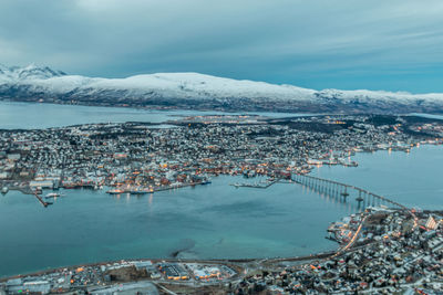 Aerial view of town by sea during winter