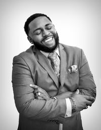 Portrait of a smiling young man against white background