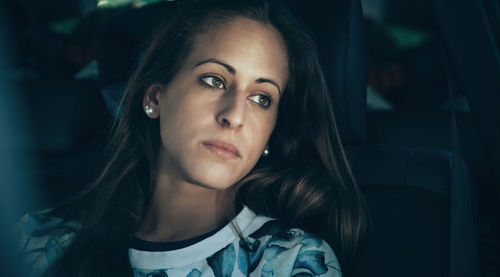 Young woman crying while sitting in car