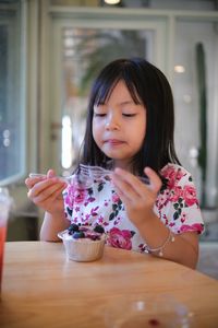 Kid happy with a cake at the cafe