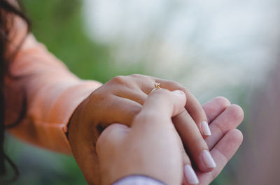 Close-up of couple holding hands