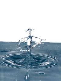 Close-up of splashing water over white background