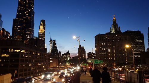 Illuminated city street and buildings at night