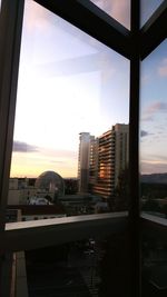 Buildings in city at sunset