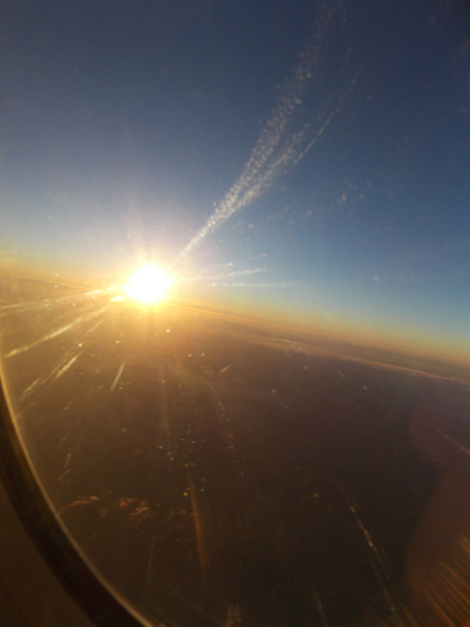 VIEW OF AIRPLANE WING OVER LANDSCAPE