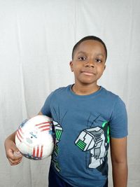 Portrait of boy holding. soccer ball