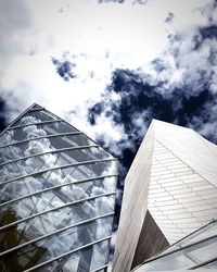 Low angle view of glass building against sky