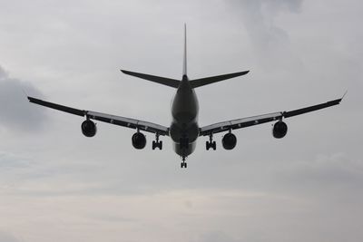 Low angle view of airplane flying in sky