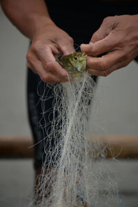 Close-up of man holding fishing net