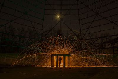 Illuminated lights against sky at night