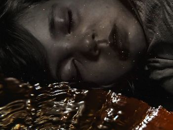 Close-up portrait of woman with drink in water