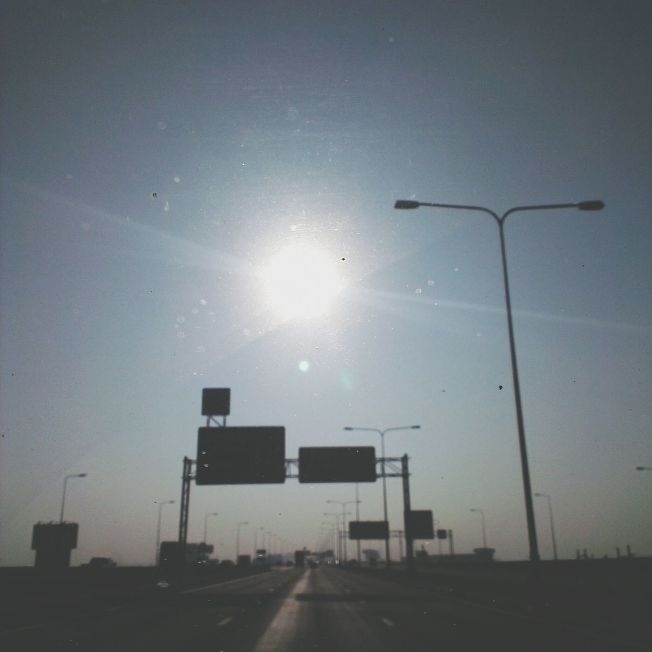 STREET LIGHT ON ROAD AGAINST SKY