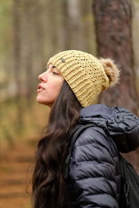Rear view of woman wearing hat in woods