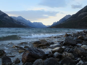 Scenic view of sea and mountains against sky