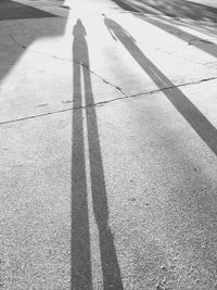 Low section of person shadow on road