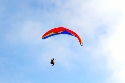 Low angle view of paragliding against sky