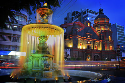 Statue of illuminated building at night