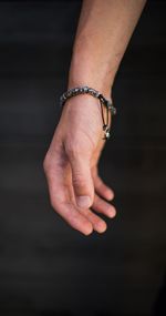 Close-up of human hand against black background