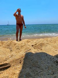 Full length of man standing on beach