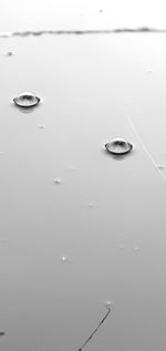 High angle view of raindrops on water surface