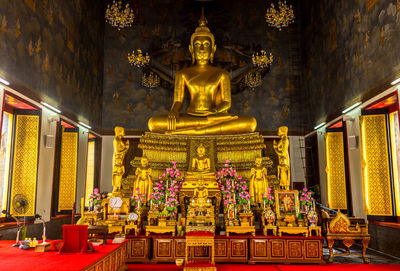 Statue of buddha in temple outside building