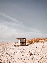 Built structure on beach against sky