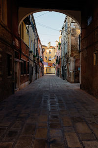 Footpath amidst buildings in city