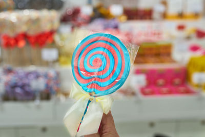 Close-up of hand holding multi colored candies