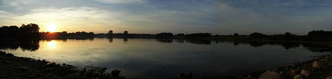 Scenic view of lake at sunset