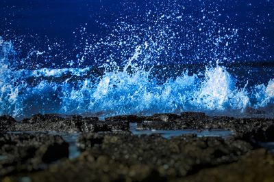 Close-up of sea against blue sky at night