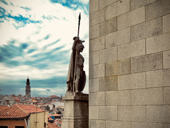 Statue of building against cloudy sky