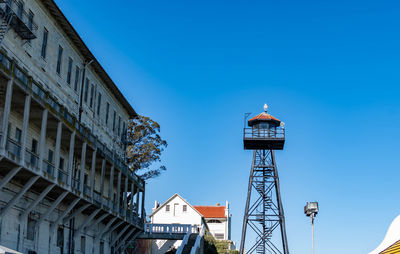 Low angle view of buildings against clear blue sky