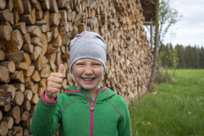 Portrait of smiling boy standing against stone wall