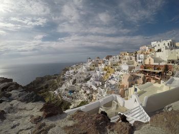 High angle view of townscape by sea against sky