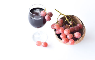 High angle view of grapes on table against white background