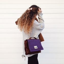 Woman wearing sweater while walking against wall