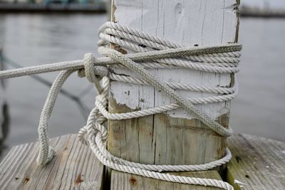 Close-up of rope tied on pier