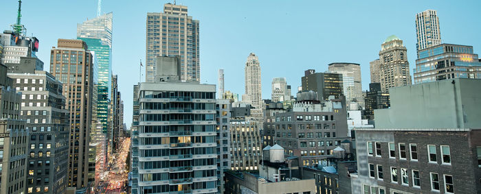 Modern buildings in city against clear sky