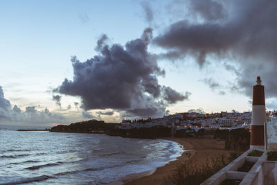 Panoramic view of sea and cityscape against sky