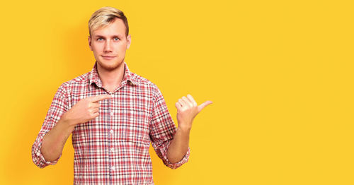 Portrait of mature man against yellow background
