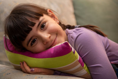 Portrait of young woman lying on blanket