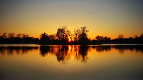 Scenic view of lake against sky during sunset