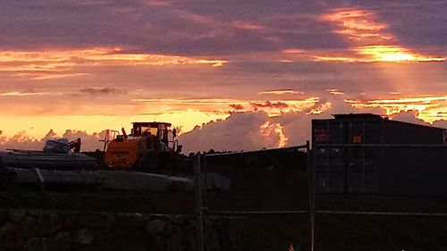 Silhouette buildings against sky during sunset