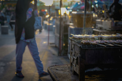 People standing at market stall in city