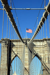 Low angle view of suspension bridge against sky