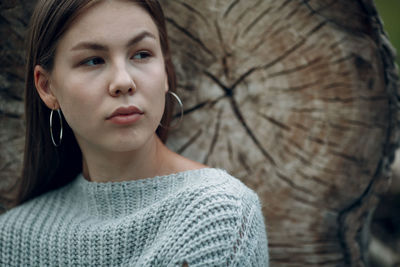 Close-up portrait of young woman looking away