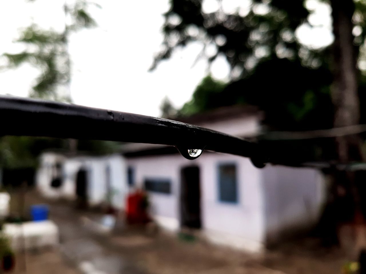 CLOSE-UP OF WET METAL RAILING