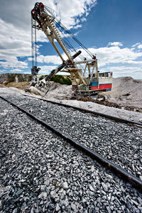 Railroad track against cloudy sky