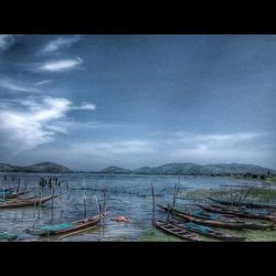 Scenic view of lake against cloudy sky