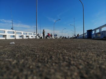 People on street in city against sky